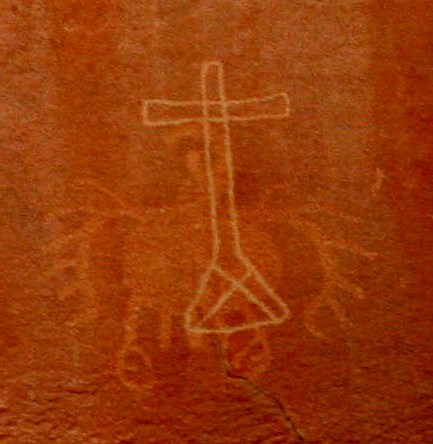 Condor; fragment of pre-Columbian rock art engraving in the Atacama Desert, Chile. The cross was painted centuries after,  presumably by catholic missionaries. Photo: Ximena Jordan.